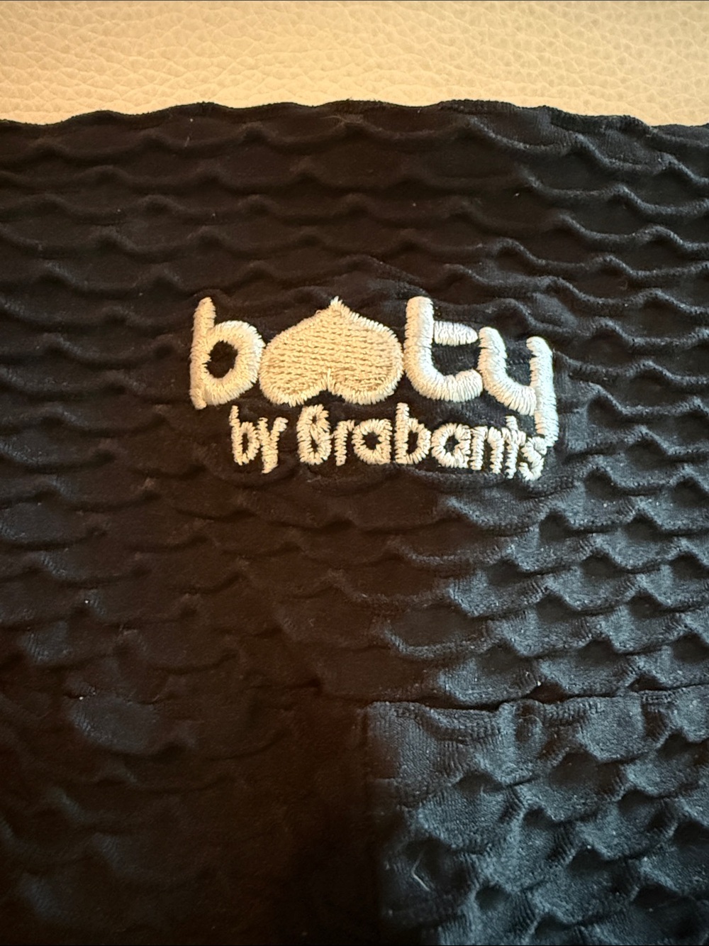 Booty by Brabants Black Quilted Baby Bib with White Logo